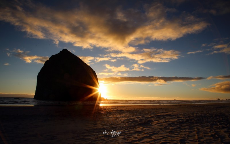 The Haystack Rock on the Canon beach is probably one of the most photographed landscape in Oregon. This image of the giant rock partially obscuring the sun was captured right before the sunset.